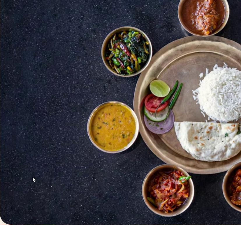 Traditional Chennai meal served on a brass plate